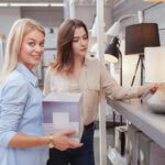 Two young women buying home lighting