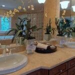 a luxury bathroom with duo amenities and granite counter top