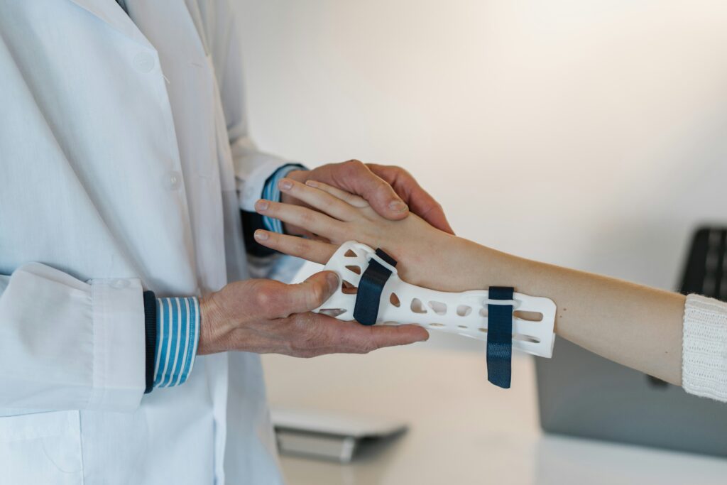 Doctor placing a brace on a wrist