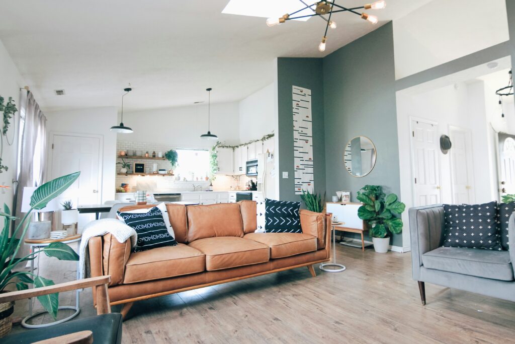 A living room with a brown leather couch.