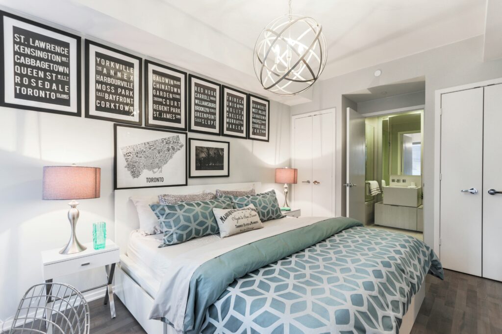 A bedroom with black wall art.