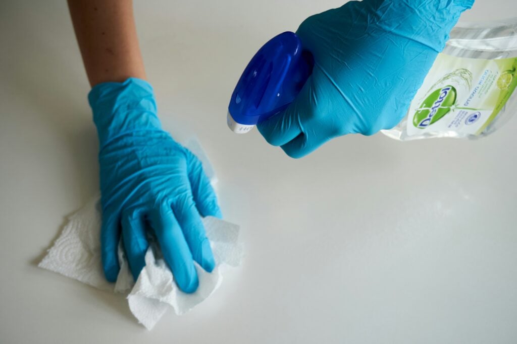 Hands with blue gloves cleaning