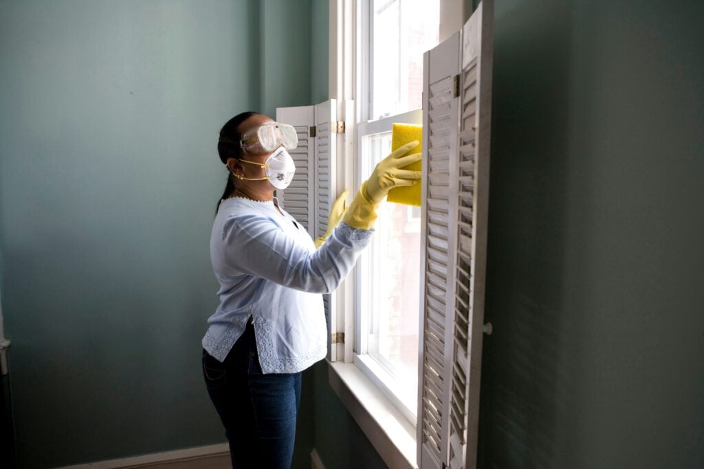 Woman cleaning window