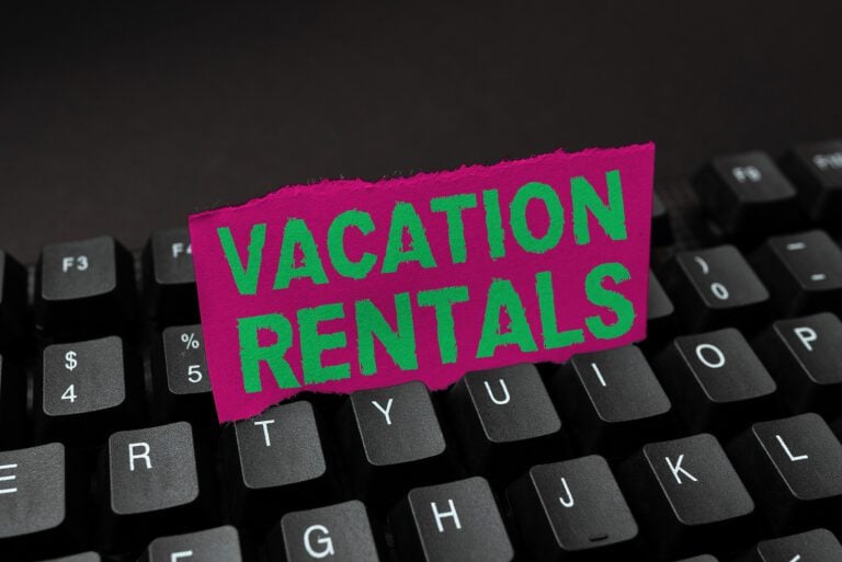 Writing displaying text "Vacation Rentals" on a black keyboard