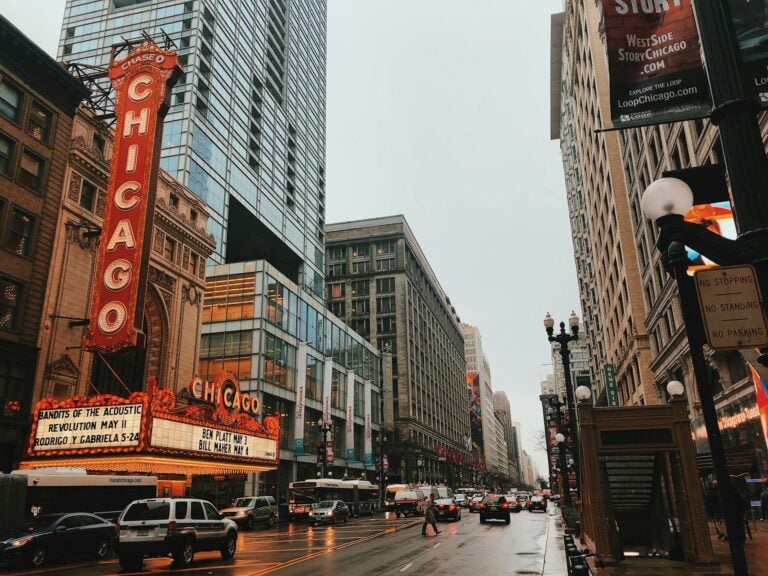 Different vehicles on the road near Chicago buildings