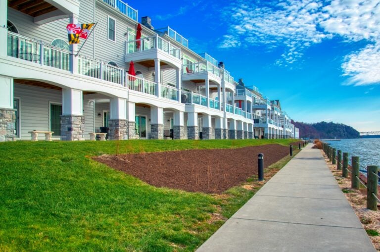 A row of apartment buildings next to a body of water