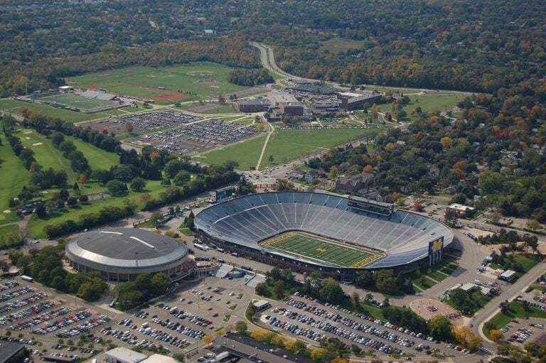 Aerial Photo of the Michigan football stadium at Ann Arbor Michigan. Local high school in the background. Left side of the stadium is Crisler Arena for Michigan college ball team.