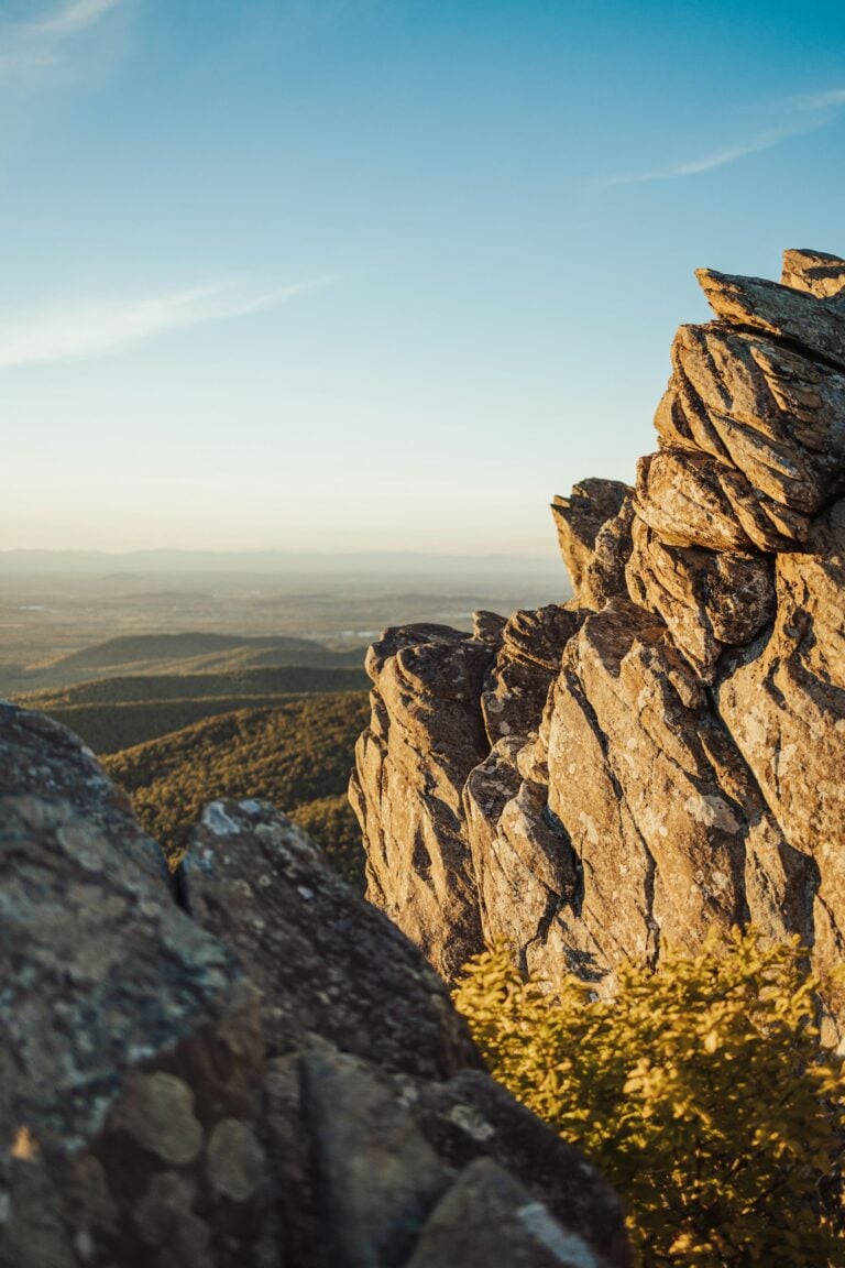 A rocky cliff with a valley below